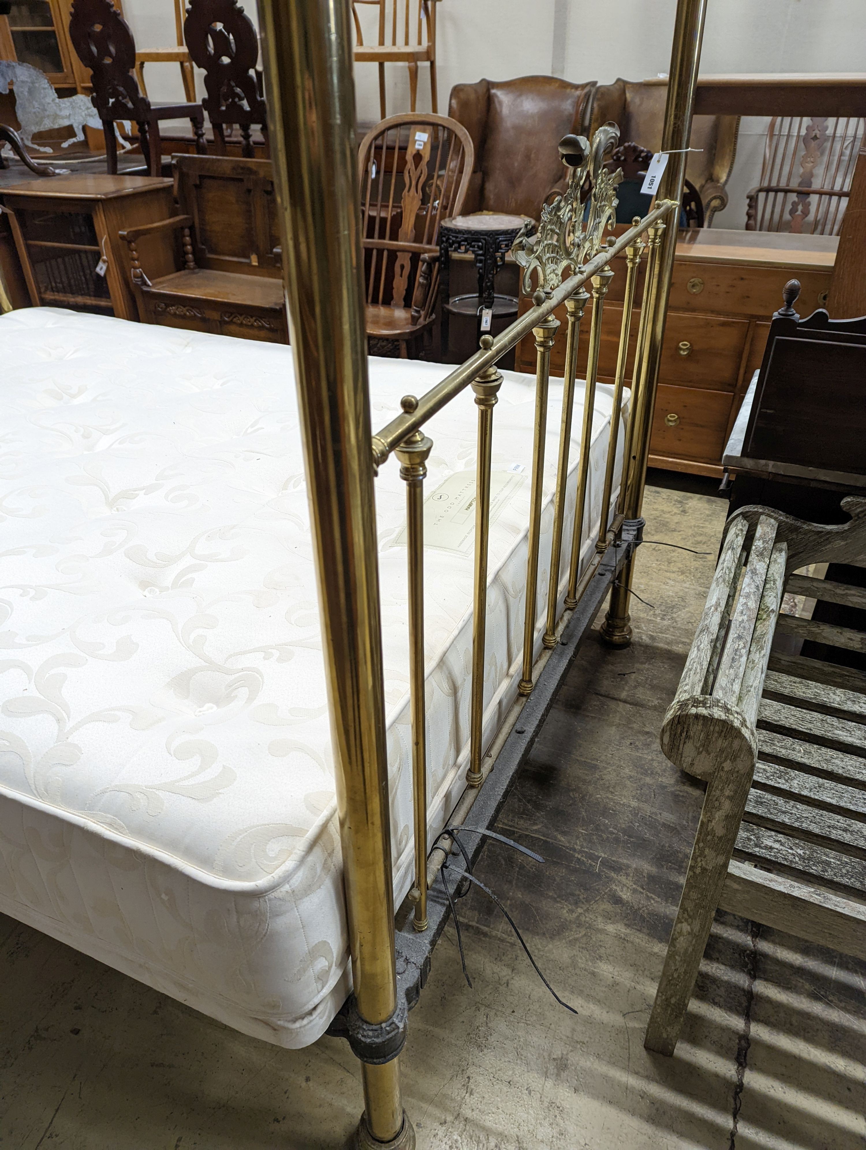 A Victorian style brass four poster double bed frame, with an Odd Mattress Company Hampton 150cm mattress